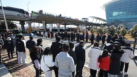 Mourners wait to pay tribute to the victims of a plane fire at a memorial altar at Muan International Airport in Muan, South Korea, Wednesday, Jan. 1, 2025. 