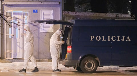 Police investigators work at the site of a shooting in Cetinje, 36 kilometers (22 miles) west of Podogrica, Montenegro on Wednesday.