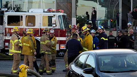 Firefighters respond to a commercial building where a small plane crashed on Thursday.