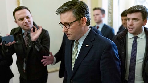 Speaker of the US House of Representatives Mike Johnson (R-La.), followed by reporters, walks to the House Chamber at the Capitol in Washington, Friday, Dec. 20, 2024.