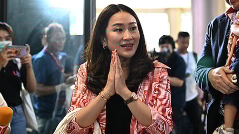 Thailand's Prime Minister Paetongtarn Shinawatra, the youngest daughter of former PM and billionaire Thaksin Shinawatra, holds a handbag as she arrives at the party headquarters in Bangkok on May 14, 2023.