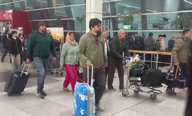 Passengers at Indira Gandhi International Airport during a cold and foggy winter morning, in New Delhi, Saturday, Jan. 4, 2025.