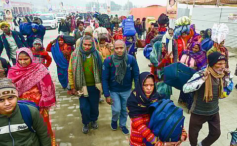 Devotees arrive at Sangam ahead of Maha Kumbh Mela 2025, in Prayagraj, Sunday, Jan. 5, 2025.