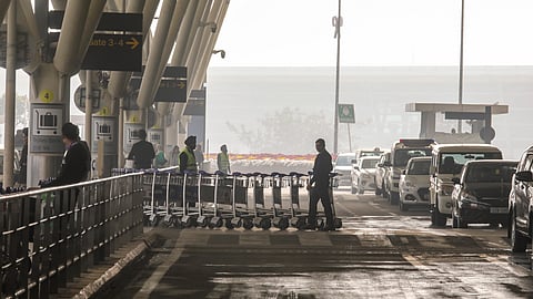 Staff of Indira Gandhi International Airport during a cold and foggy winter morning, in New Delhi, Saturday, Jan. 4, 2025.