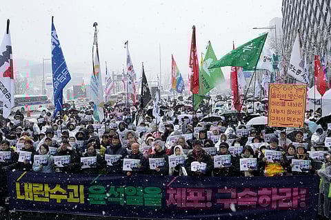 Protesters stage a rally demanding the arrest of impeached South Korean President Yoon Suk Yeol near the presidential residence in Seoul, South Korea, Sunday, Jan. 5, 2025. The letters read "Arrest Yoon Suk Yeol."