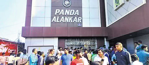 Locals gather in front of Panda Alankar shop in Panikoili