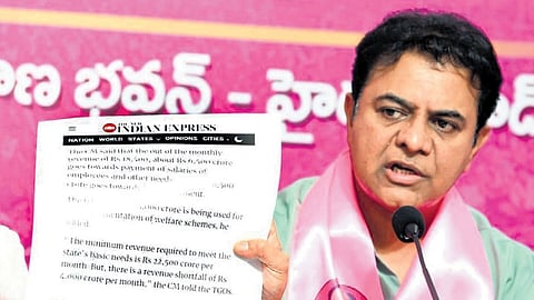 BRS working president KT Rama Rao shows a clip of the news article published in TNIE during a press conference at Telangana Bhavan on Sunday