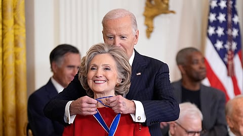 President Joe Biden, right, presents the Presidential Medal of Freedom, the Nation's highest civilian honor, to former Secretary of State Hillary Clinton, in the East Room of the White House.