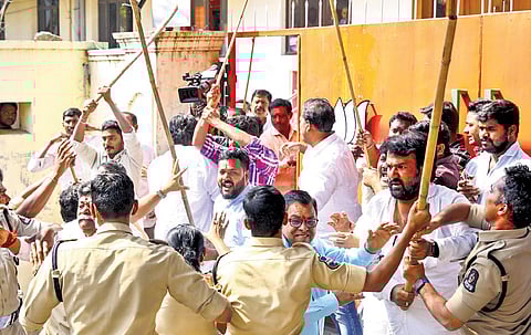 Police try to disperse the Youth Congress activists from the BJP party office at Nampally in Hyderabad on Tuesday