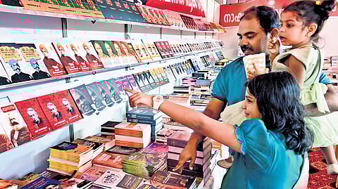 A family visiting the stall at the Kerala Legislature International Book Fair 