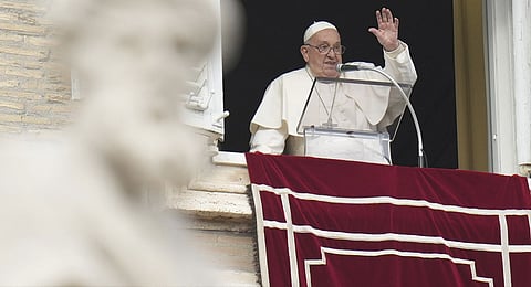 Pope Francis waves during the Angelus noon prayer on the occasion of the Epiphany day from the window of his studio overlooking St.Peter's Square, at the Vatican, Monday, Jan. 6, 2025. 