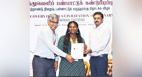 Ex-IAS officer R Balakrishnan (left) and Finance Secretary T Udhayachandran giving certificates to students