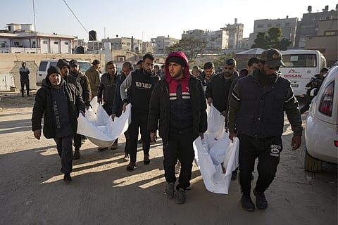 Mourners carry the bodies of their relatives killed in the Israeli bombardment of the Gaza Strip, during their funeral at Al-Aqsa Martyrs Hospital in Deir al-Balah, Wednesday, Jan. 8, 2025. 