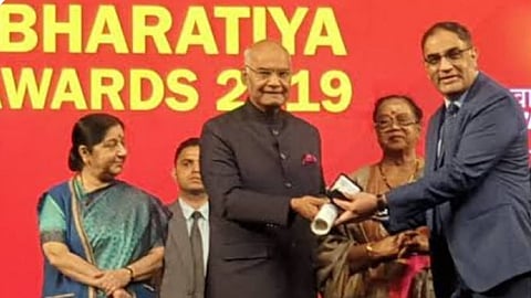Commander Tiwari receiving the  Pravasi Bharatiya Divas award.