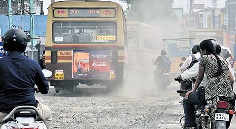 A cloud of dust rises from damaged portion of PH Road at Velappanchavadi