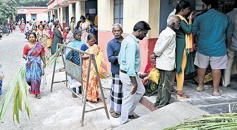 People standing in queue in front of a ration card