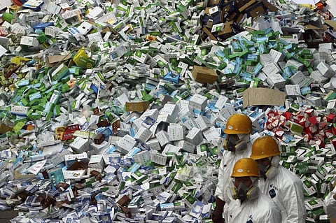 Workers prepare to destroy over 50 tons of confiscated fake medicine during a campaign to mark World Consumer Rights Day in Beijing, Thursday March 15, 2012. 