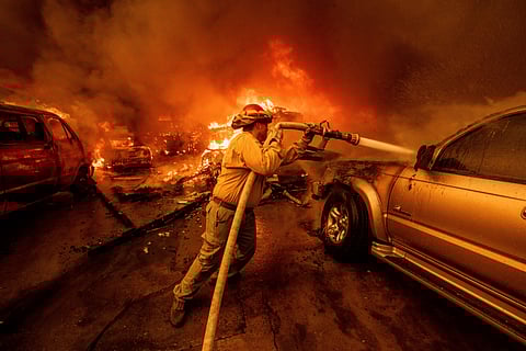 A worker surveys the damage from the Palisades Fire in the Pacific Palisades neighbourhood of Los Angeles, Monday, Jan. 13, 2025.