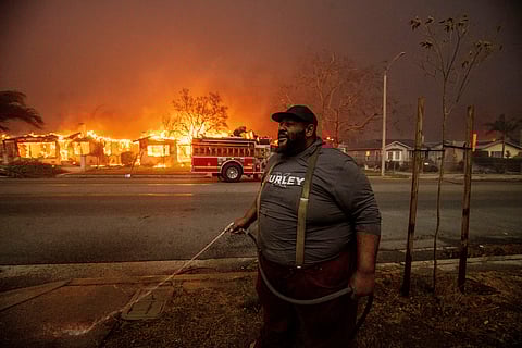 A firefighter battles the Palisades Fire as it burns a structure in the Pacific Palisades neighbourhood of Los Angeles, Jan. 7, 2025.