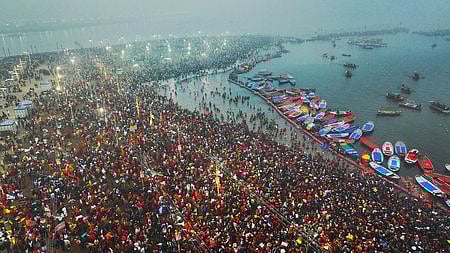 Devotees take a holy dip at Sangam during Maha Kumbh Mela 2025. 