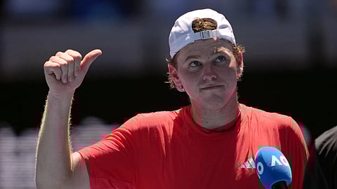 Alex Michelsen of the US reacts as he is interviewed on court following his first round win over Stefanos Tsitsipas of Greece at the Australian Open tennis championship in Melbourne, Australia, Mon, Jan 13, 2025.