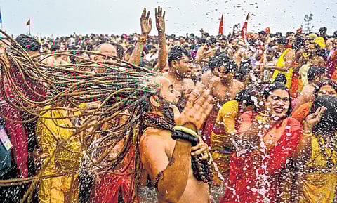 ‘Sadhus’ and other devotees take a holy dip at the Sangam on Makar Sankranti festival during the Maha Kumbh Mela in Prayagraj, Uttar Pradesh on Tuesday. 