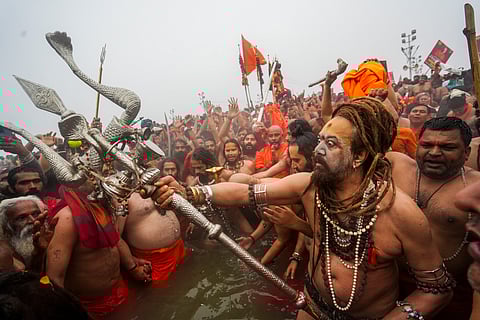 'Naga sadhus' of 'Juna Akhada' and other devotees take a holy dip at the Sangam on the occasion of 'Makar Sankranti' festival, during the Maha Kumbh Mela 2025