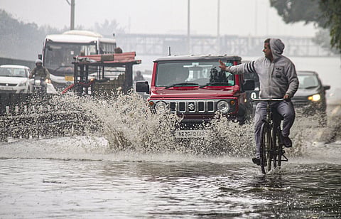 File | Vehicles move through a waterlogged service road of the Delhi-Gurugram Expressway after heavy rains, in Gurugram, Thursday, Jan. 16, 2025