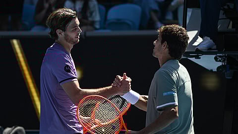 USA's Taylor Fritz (L) shakes hands with Chile's Cristian Garin (R) after winning their men's singles match on day five of the Australian Open tennis tournament in Melbourne on January 16, 2025.