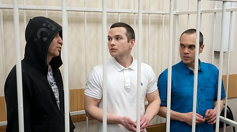 Lawyers Igor Sergunin, from left, Alexei Liptser and Vadim Kobzev, all who once represented late opposition leader Alexei Navalny, stand in a courtroom in Petushki, Vladimir region, about 120 kilometers (75 miles) east of Moscow, Russia.