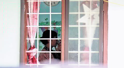 Dhanya, the neighbour of deceased Vinisha, watching news of the murder on the television 