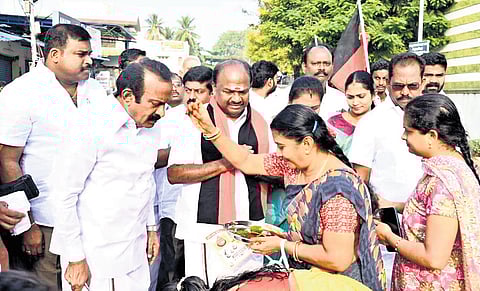 DMK candidate with Minister S Muthusamy in Erode on Saturday 