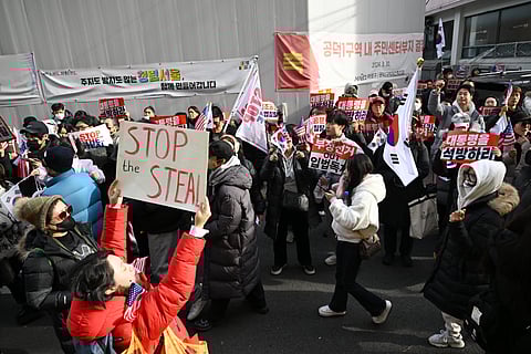 Pro-Yoon supporters demonstrate outside the Seoul Western District Court in Seoul on January 18, 2025, as the court weighs whether to extend the detention of impeached South Korea President Yoon Suk Yeol, after investigators arrested him over a failed martial law bid.