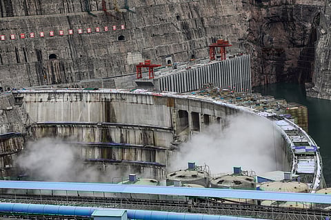 This photo taken on June 22, 2021 shows water being released from the 289-metre (948 ft.) tall Baihetan Hydropower Station, taken from the Liangshan side of the dam in China's southwestern Sichuan province.