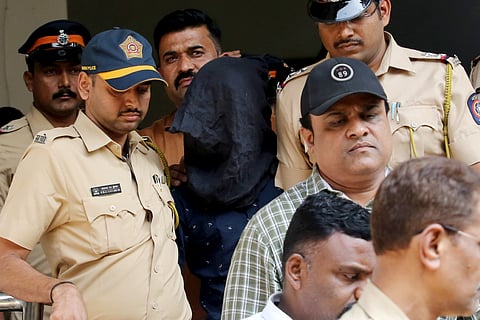 Police personnel take the accused, arrested in connection with the alleged attack on Bollywood actor Saif Ali Khan, to a hospital for medical examination before producing him at a court, in Mumbai, Sunday, Jan. 19, 2025. 