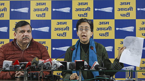 Delhi Chief Minister and AAP leader Atishi with party leader Sanjay Singh addresses a press conference.