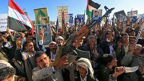 Demonstrators shout slogans and raise their assault rifles during a rally to denounce Israel and in solidarity with Palestinians in the Huthi-controlled capital Sanaa, on January 17, 2025.