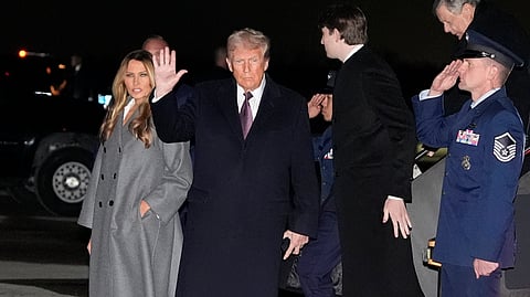 President-elect Donald Trump and Melania Trump, walk off an Air Force Special Mission airplane as they arrive at Dulles International Airport, Saturday.