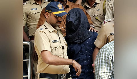 Police personnel take the accused, arrested in connection with the alleged attack on Bollywood actor Saif Ali Khan, to a hospital for medical examination before producing him at a court, in Mumbai, Sunday, Jan. 19, 2025.