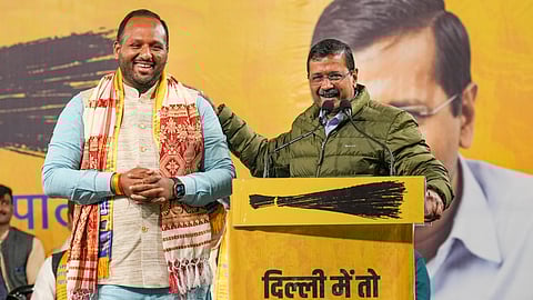  AAP National Convener Arvind Kejriwal with party candidate from Vishwas Nagar constituency Deepak Singla during a campaign rally ahead of the Delhi Assembly election, in New Delhi.