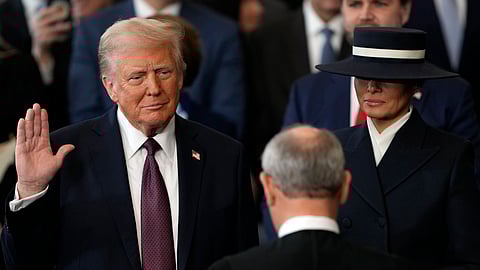 Donald Trump is sworn in as the 47th president of the United States by Chief Justice John Roberts as Melania Trump holds the Bible during the 60th Presidential Inauguration in the Rotunda of the U.S. Capitol in Washington, Monday, Jan. 20, 2025