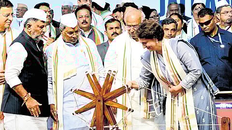 Wayanad MP Priyanka Gandhi spins a charkha to inaugurate Congress’ Jai Bapu, Jai Bhim, Jai Samvidhan rally, as AICC president Mallikarjun Kharge, CM Siddaramaiah, DCM DK Shivakumar, and other leaders look on, in Belagavi on Tuesday