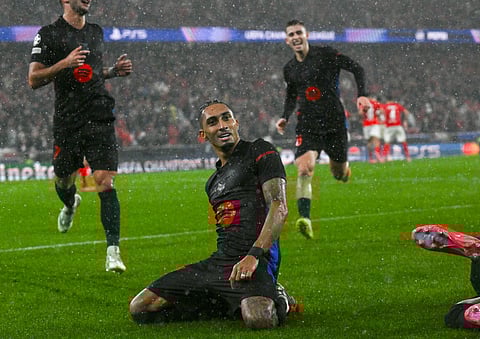 Barcelona's Brazilian forward #11 Raphinha celebrates victory with teammates at the end of the UEFA Champions League, league phase football match between SL Benfica and FC Barcelona at Luz stadium in Lisbon on January 21, 2025.