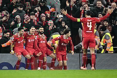 Liverpool's Egyptian striker Mohamed Salah (C) celebrates with teammates after scoring his team first goal during the UEFA Champions League football match between Liverpool and Lille LOSC at Anfield in Liverpool, 