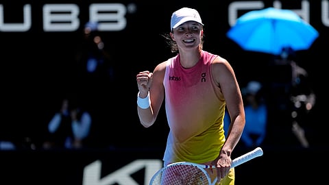 Iga Swiatek of Poland celebrates after defeating Emma Navarro of the U.S. in their quarterfinal match at the Australian Open tennis championship in Melbourne, Australia, Wednesday, Jan. 22, 2025. 