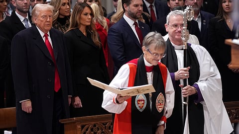 President Donald Trump, left, watches as Rev. Mariann Budde, second right, arrives at the national prayer service at the Washington National Cathedral, Tuesday, Jan. 21, 2025