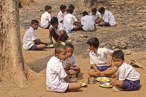 File | School children having Mid Day Meal in a school in Chandragiri 