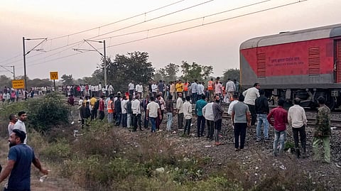 People gather after a train mishap, in Jalgaon district, Maharashtra.