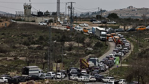 Commuters wait in their vehicles at the Israeli Atara checkpoint on route 465 near Ramallah in the occupied West Bank on January 22, 2025.