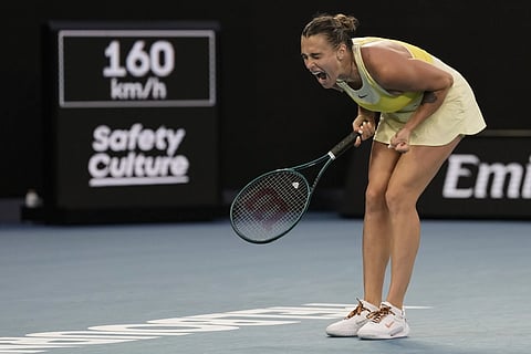 Madison Keys of the U.S. holds the Daphne Akhurst Memorial Cup at the Brighton Beach Boxes the morning after defeating Aryna Sabalenka of Belarus in the women's singles final at the Australian Open tennis championship in Melbourne, Australia, Sunday, Jan. 26, 2025.